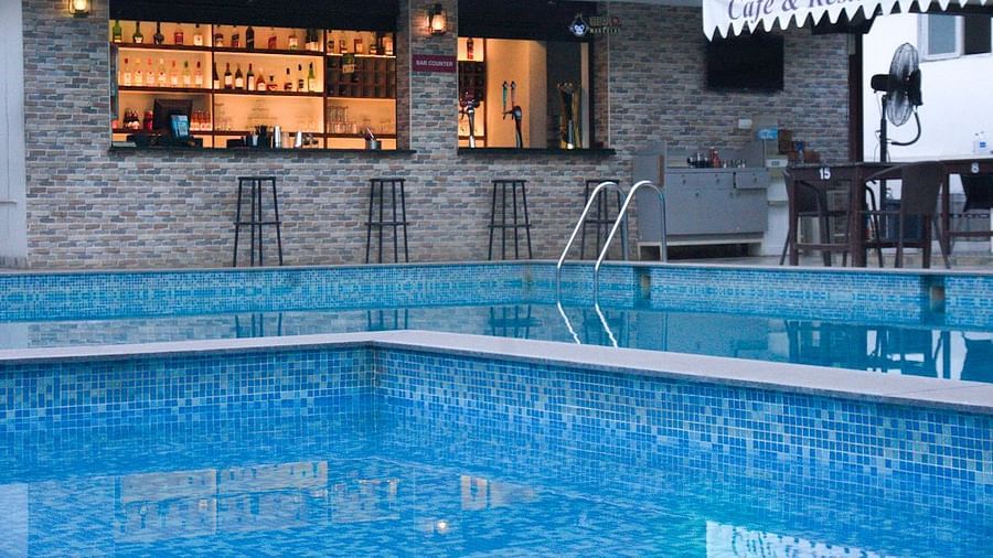 Twilight view of pool and bar at Vistar Resort. | Vistar Resort, Bengaluru
