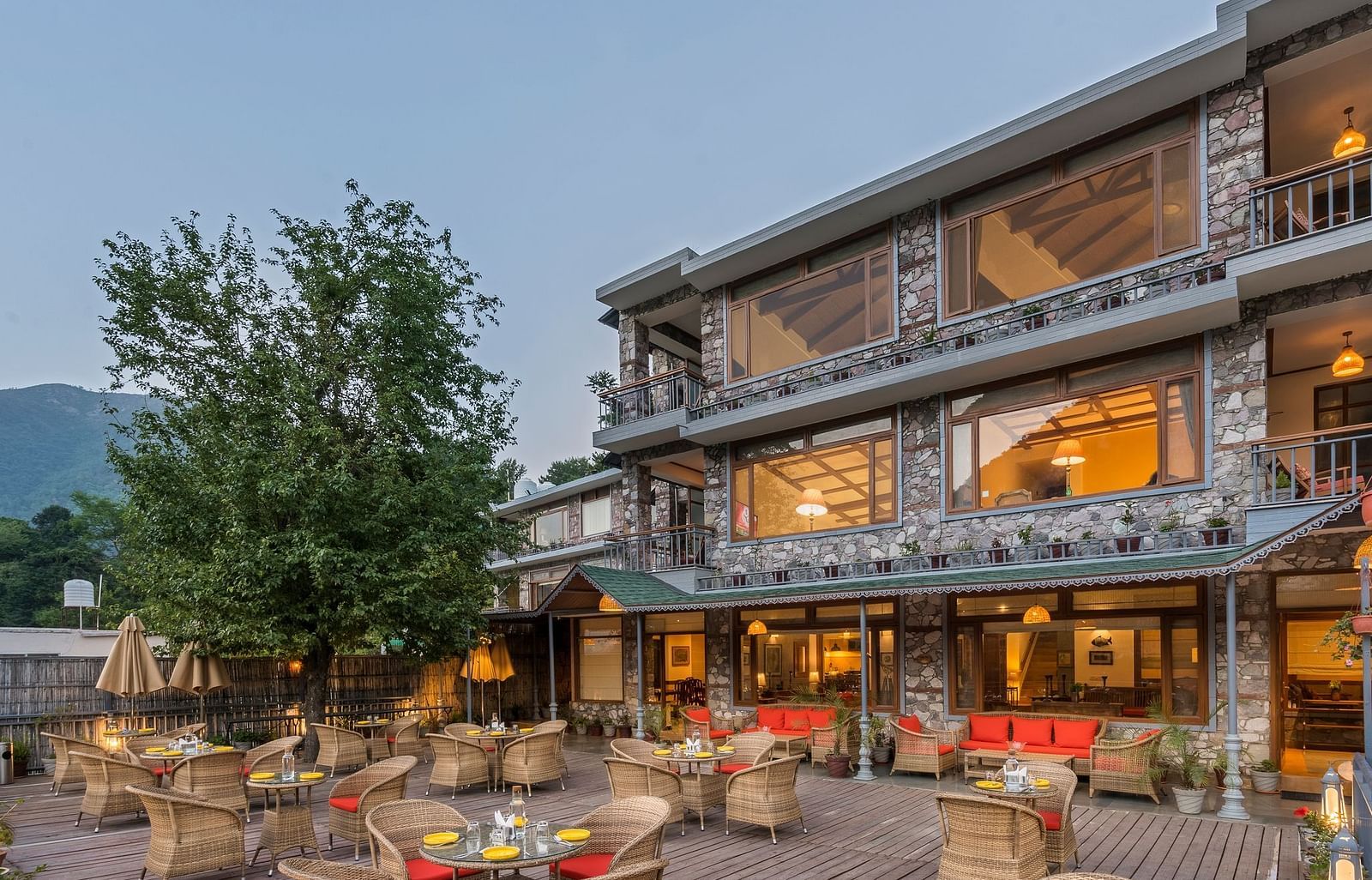 Outdoor restaurant at Fishermen's Lodge, Bhimtal, featuring a beautiful view, creating a perfect setting for dining in nature.