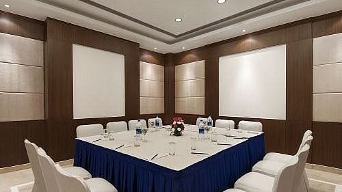 Board Room with a large square table and seating arranged on all four sides, ready for meetings and conferences at Inde Signature Tower, Gurgaon