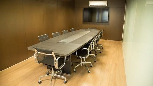 Modern conference room with a long table and chairs | Senate Boardroom | Woodstock Resorts, Coorg