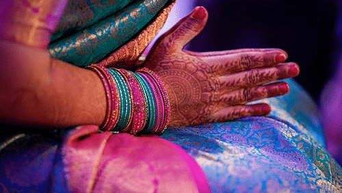 Woman holding her hands and praying - Hablis Hotel, Chennai