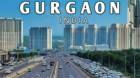 Aerial view of a multi-lane highway and modern high-rise buildings in Gurgaon, India.
