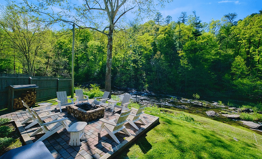 corner view of the outdoor seating area with a fire pit highlighting the mesmerizing views of the surrounding forests - Historic Tapoco Lodge