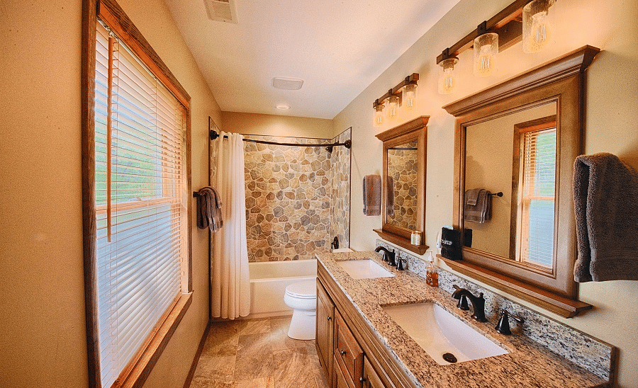 a bathroom with a large window opposite the two wash basins and a bath tub in the far end - Historic Tapoco Lodge