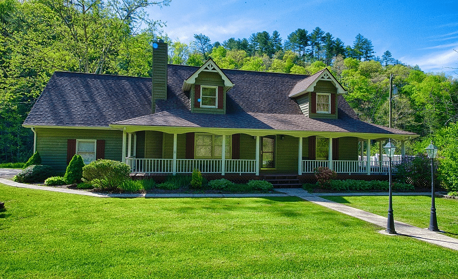 facade image of a villa with an expansive well pruned lawn in front of it - Historic Tapoco Lodge