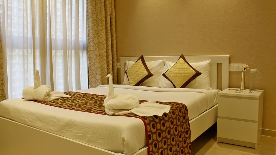 Side view of the bedroom with plush bed side table and modern interior - Maxxvalue Apartment, Hiranandani, Powai