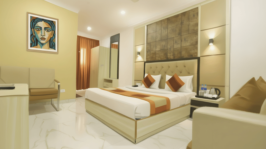 An interior view of a superior room at Hotel Apple Park Delhi, featuring a double bed with a tufted headboard, framed portrait art, and a beige sofa.