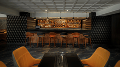 The stylish bar at Royal Tulip, Kathmandu, with comfortable seating and a well-stocked counter.