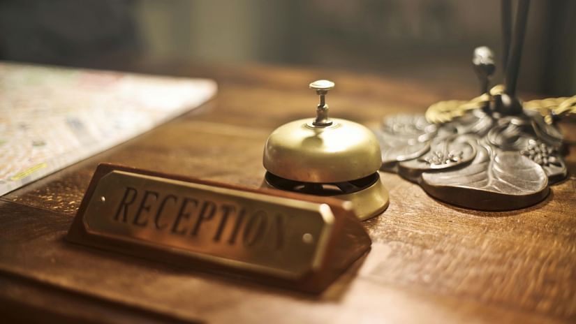 an image of a front desk with a reception bell.