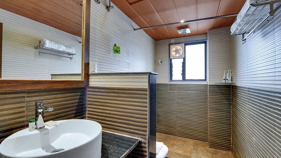 Washroom with a sink and a covered commode - Sumi Queensyard, Darjeeling