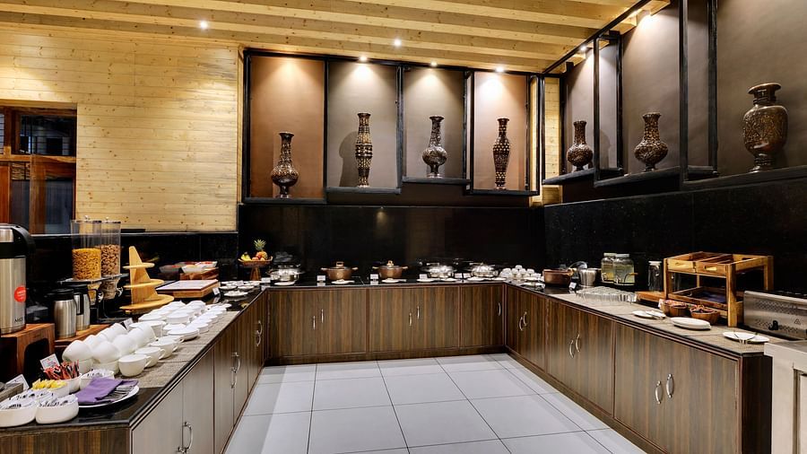 Buffet area with food items on the desk inside blue charcoal Restaurant - Sumitel Shangrila, Deorali