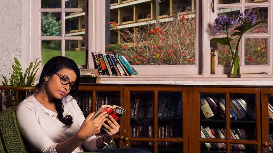 a person reading in the Library at The Carlton