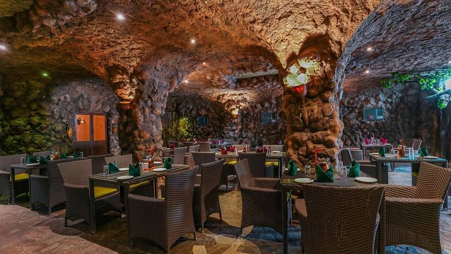 Kholong restaurant with a rock-themed décor, warm lighting, all tables, seating, and culinary arrangements arranged aesthetically6