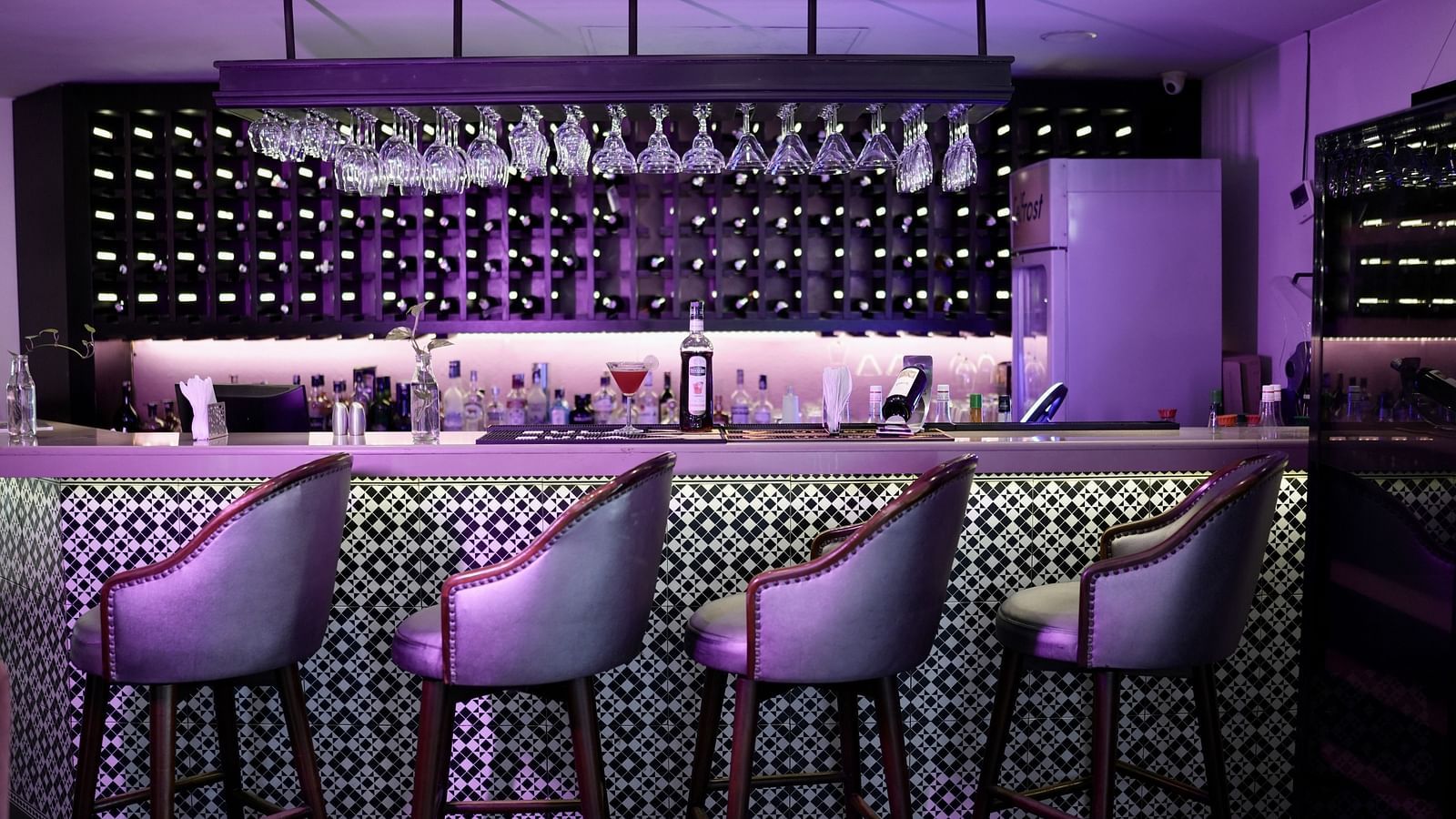 Bar area with chairs and a well-stocked bar set up, ready for an enjoyable evening