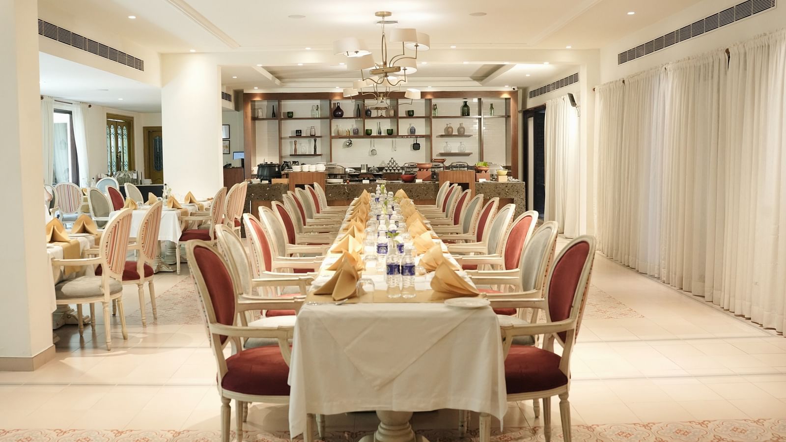 Fine dining area with numerous chairs and tables set and ready for guests.