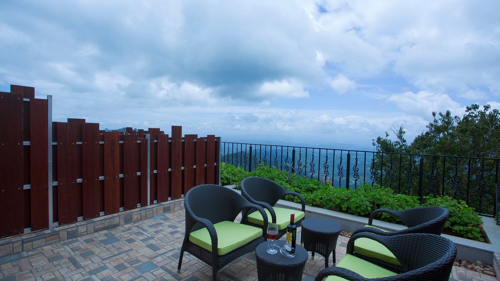 Half cloudy sky and mountain view from the balcony at Fragrant Nature Munnar.