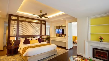 Suite with furniture arranged before the bed