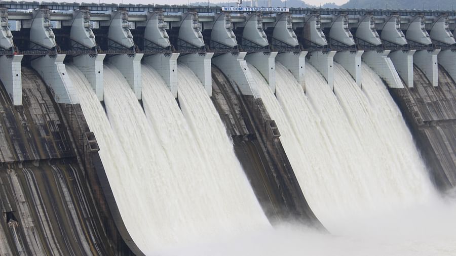 A dam with powerful flowing water cascading over its edge, creating a dramatic and dynamic scene.