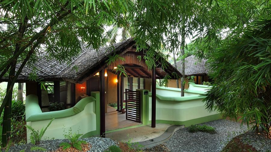 Facade view of the hotel with trees surrounding the area