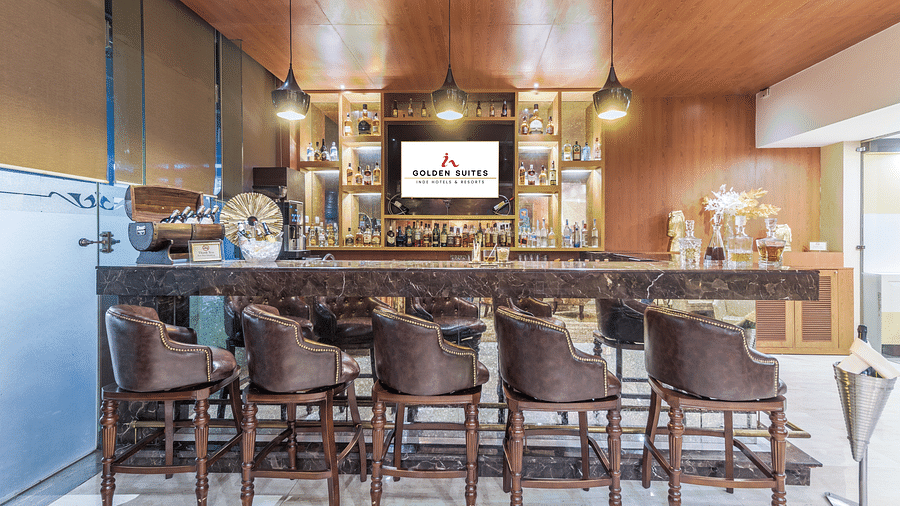 A front view of bar with aligned chair at Golden Suite