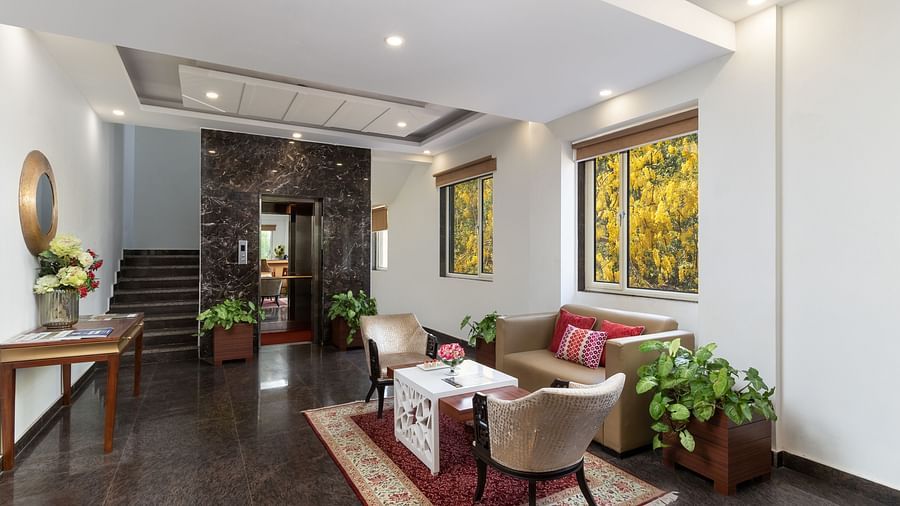 A spacious hotel lobby with comfortable seating, elegant decor, and plenty of natural light | Inde Hotel Cyber City