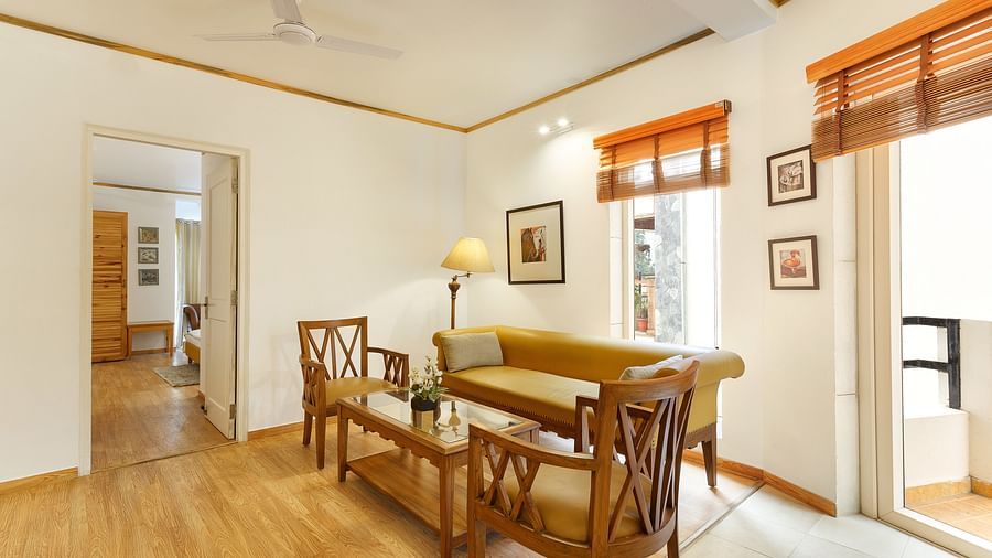 Leaving Area with chair and comfy sofa with a lamp - Pinewood Nainital 