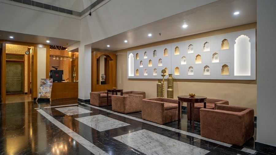 Seating lounge with modern decor near the lobby at Golden Tulip, Udaipur.