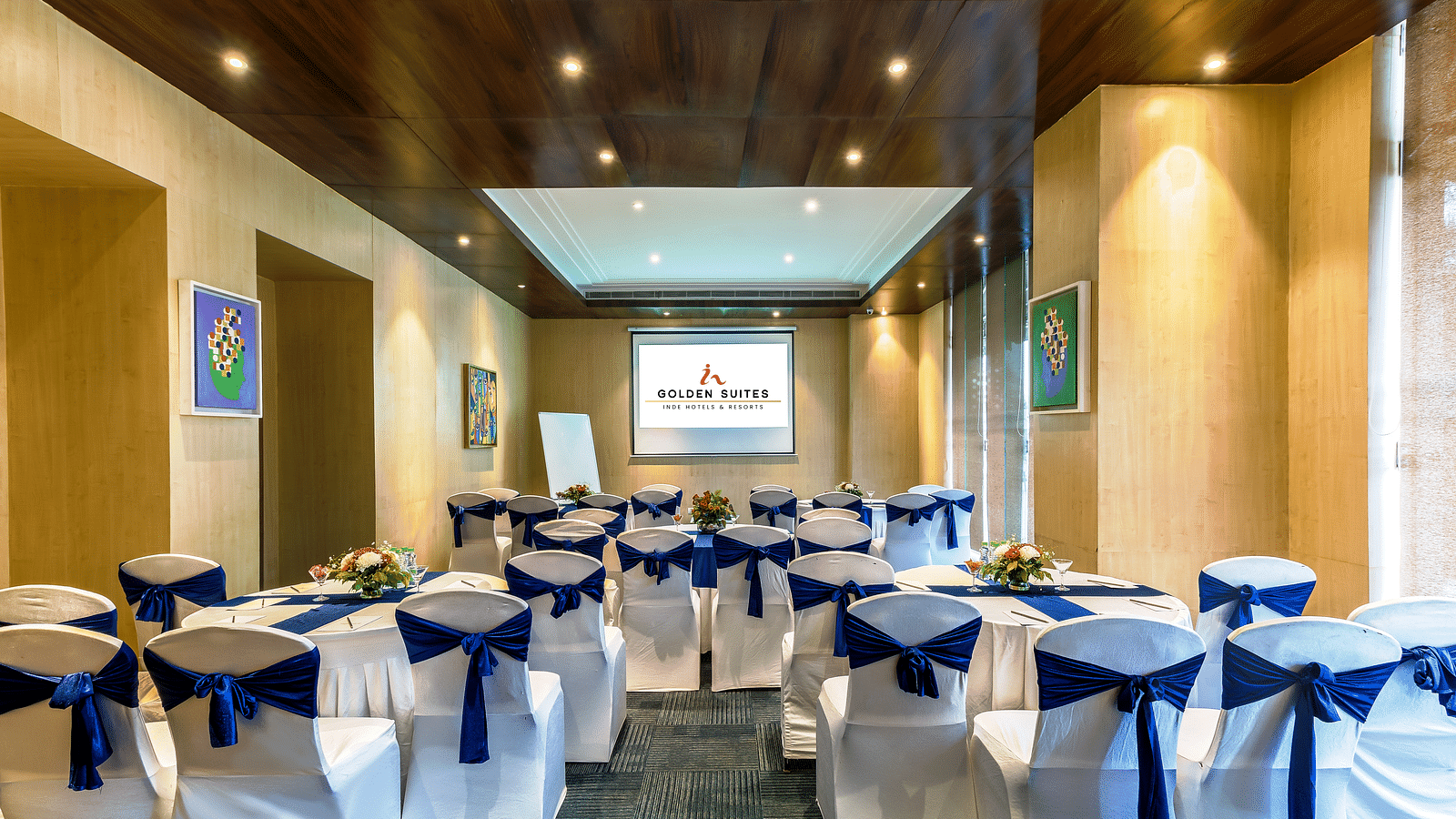 Senate 1 banquet hall with a decorated chair and screen presenter