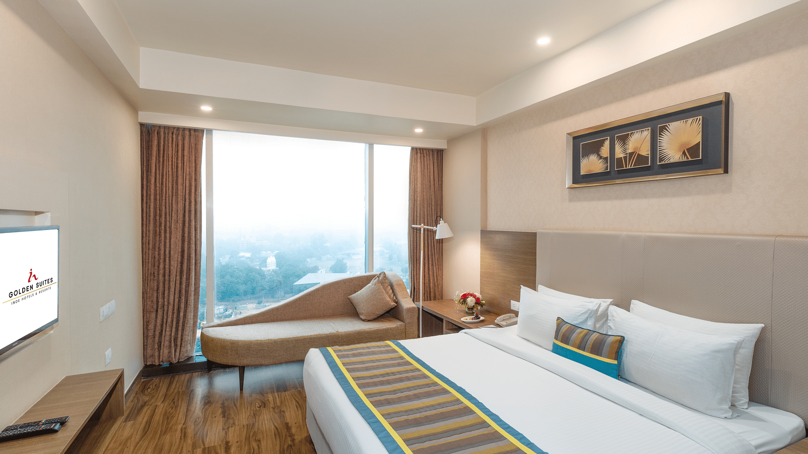 Suite Bed room with comfy bed and window view at golden suite