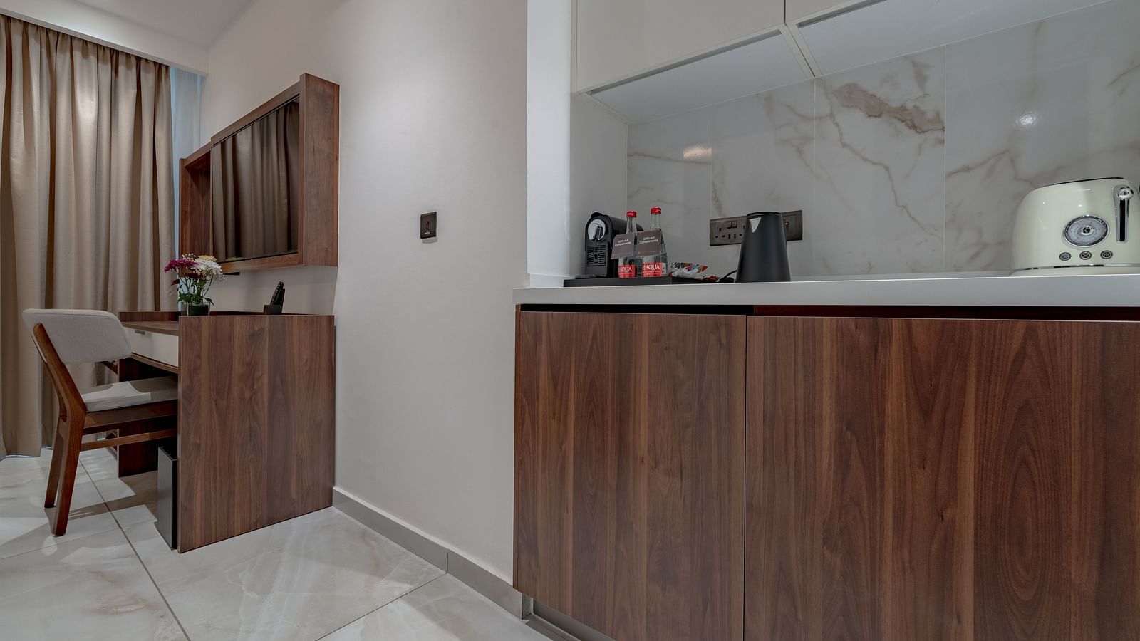 Standard Room with wooden desk, minibar, kettle, toaster, marble backsplash, and elegant lighting. - The Pelican Hotel, Accra