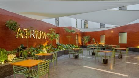 Atrium restaurant at The Pelican Hotel, Accra, featuring shaded seating and a contemporary courtyard vibe.