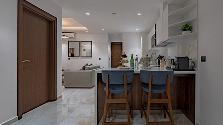 Modern Executive Suite with kitchen island, bar stools, and open floor plan. - The Pelican Hotel, Accra