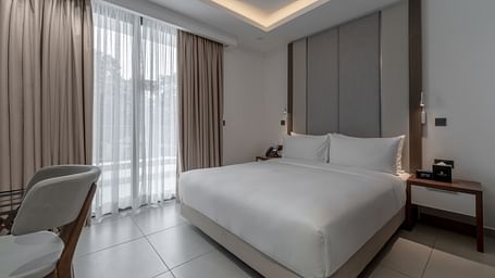 Luxurious Premier Suite offers a king bed, modern decor, and elegant furnishings for a relaxing stay. - The Pelican Hotel, Accra