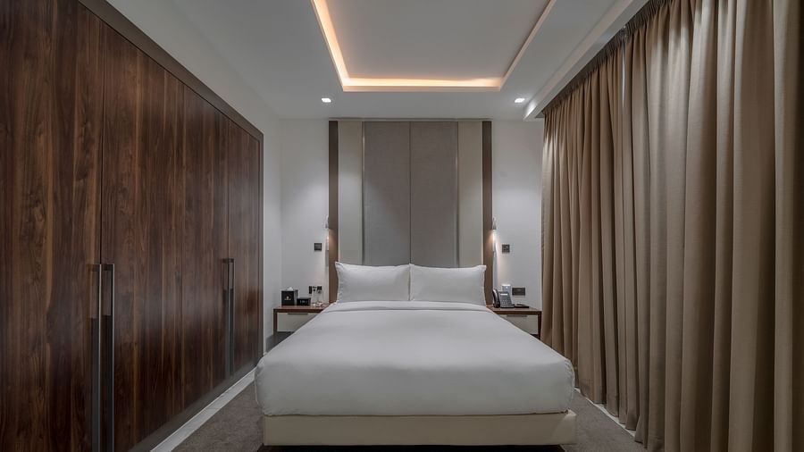A well-lit Executive Suite with a king size bed. - The Pelican Hotel, Accra