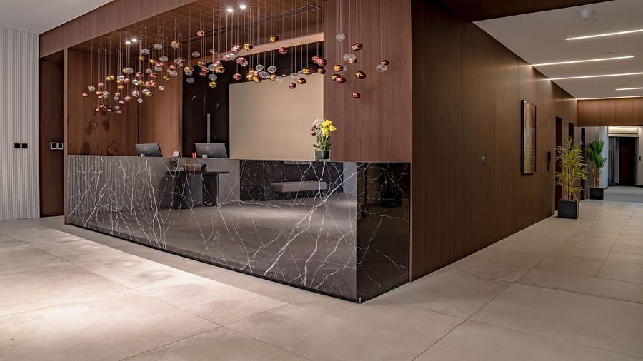 Elegant hotel lobby with marble floors, warm lighting, and modern decor. - The Pelican Hotel, Accra