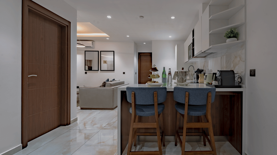 Executive Suite with kitchen island, bar stools, and open floor plan at The Pelican Hotel, a luxury hotel in Accra
