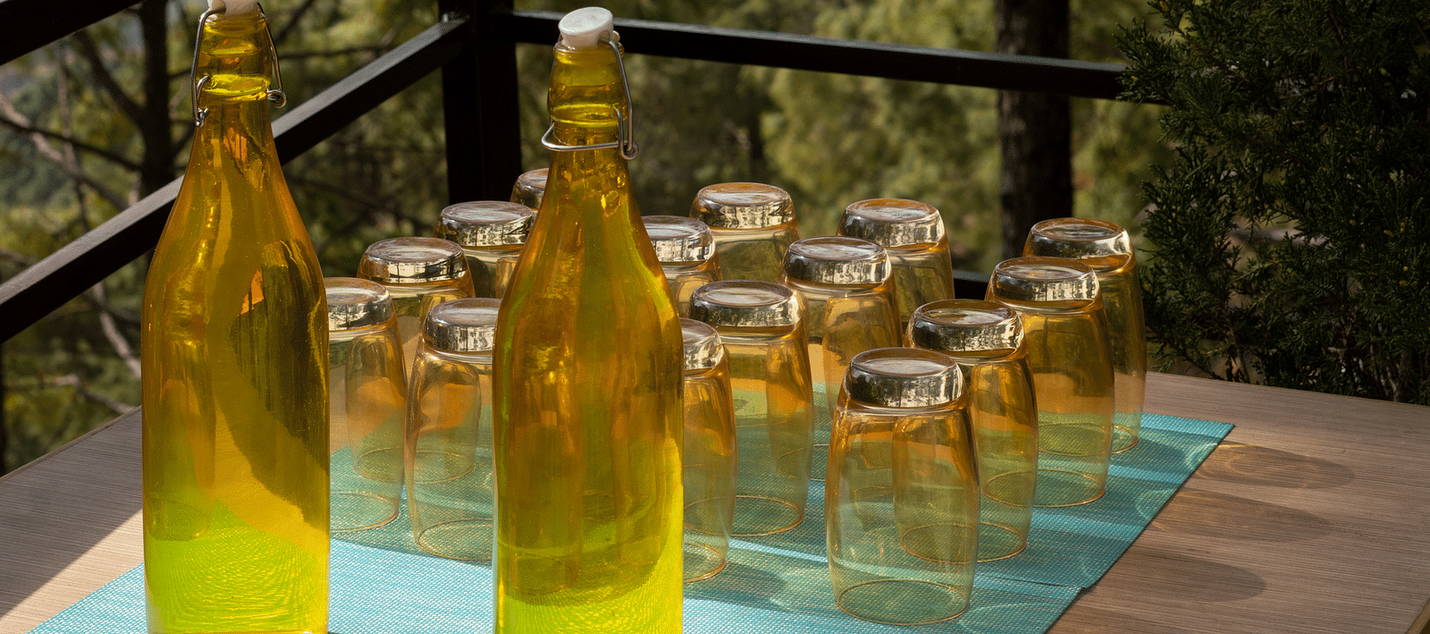 Two glass bottles and glasses arranged neatly on a table at BluSalzz Escapade Resort, Lansdowne