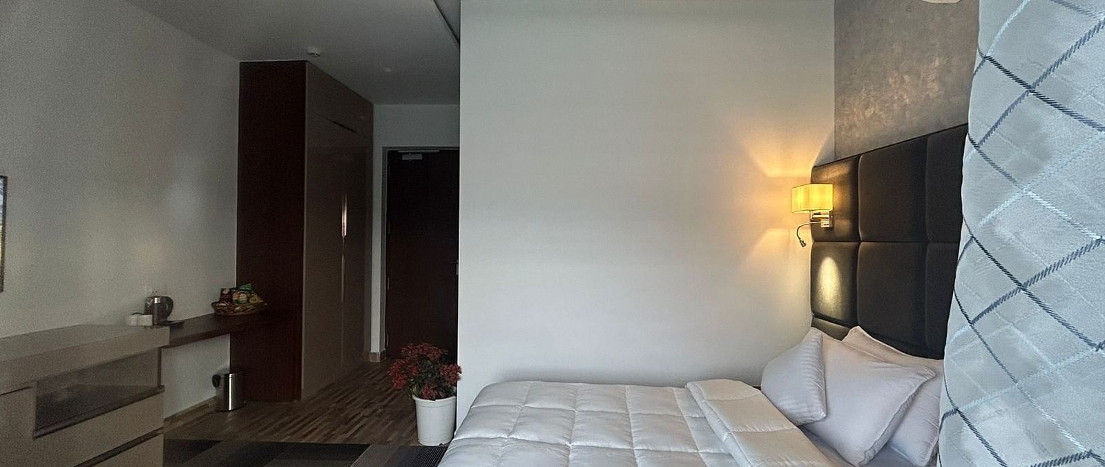 a deluxe room with modern interiors featuring a double bed at Eminence The Corbett