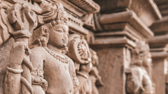 A detailed sculpture carved into the stone of a temple, showcasing intricate designs and ornate patterns.