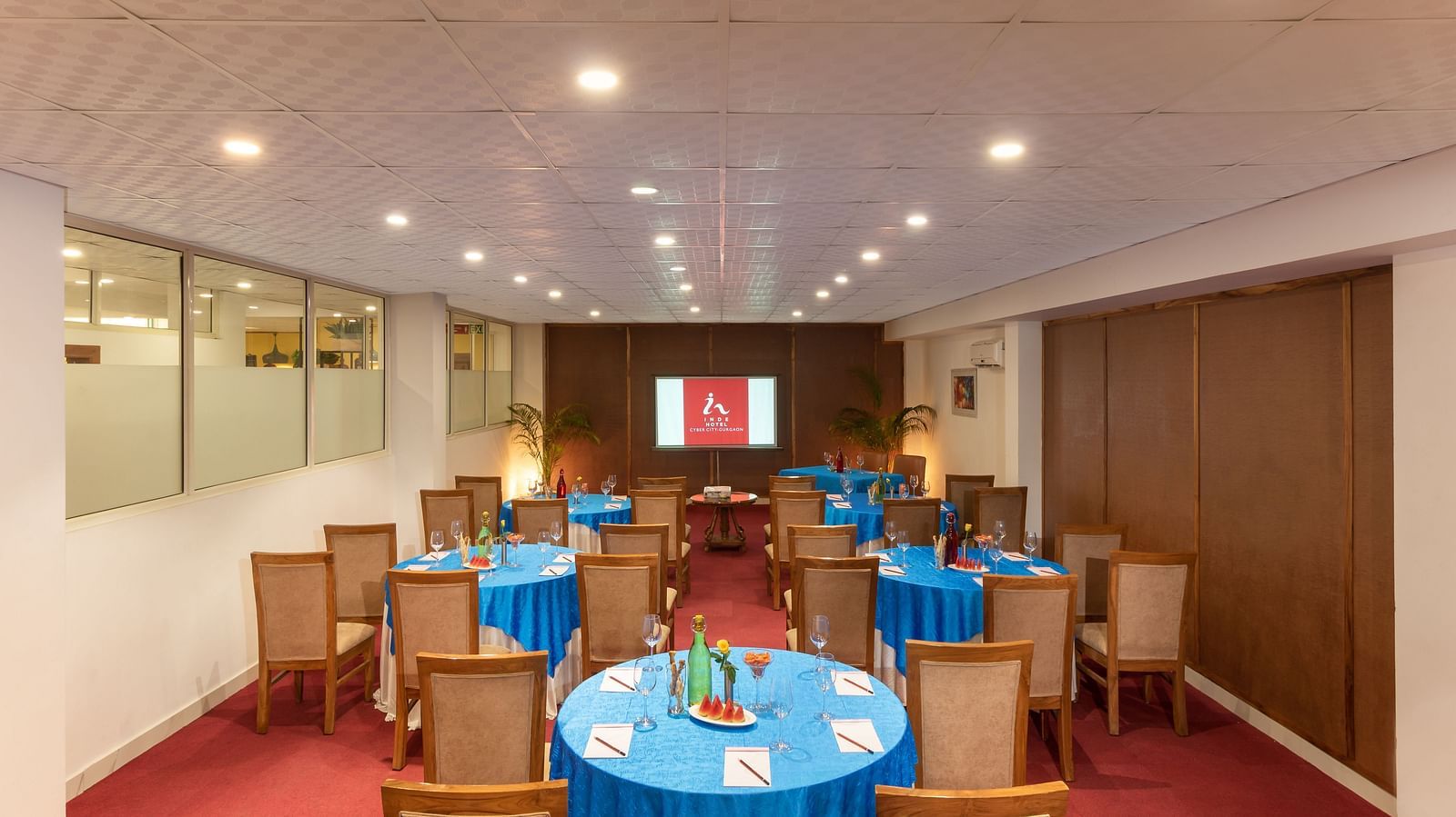 Senate Conference Hall with cluster seating arrangement, blue tables and chairs  | Inde Hotel Cyber City
