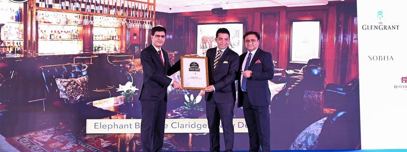 Man receiving the Great Bars of the World award on for the Elephant Bar, Claridges Collection