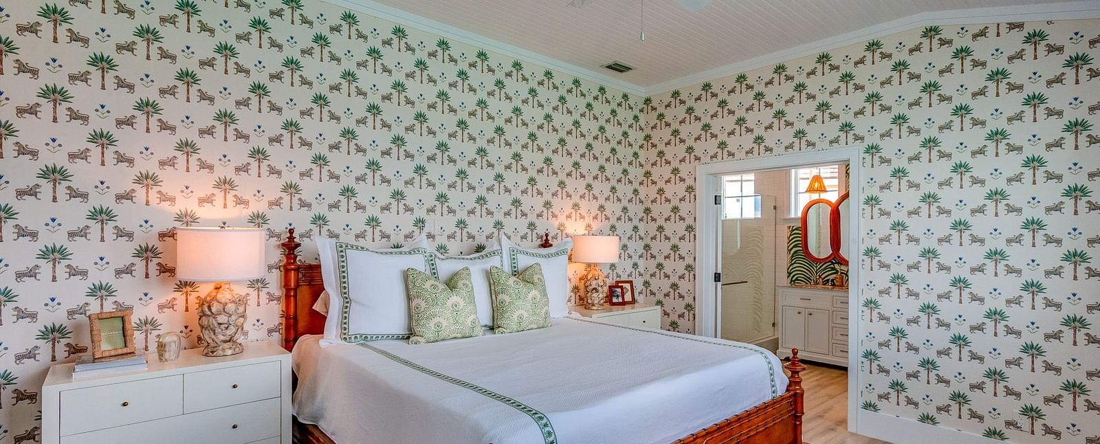 Bedroom with a bed, patterned wallpaper, and soft lighting | Abaco Inn