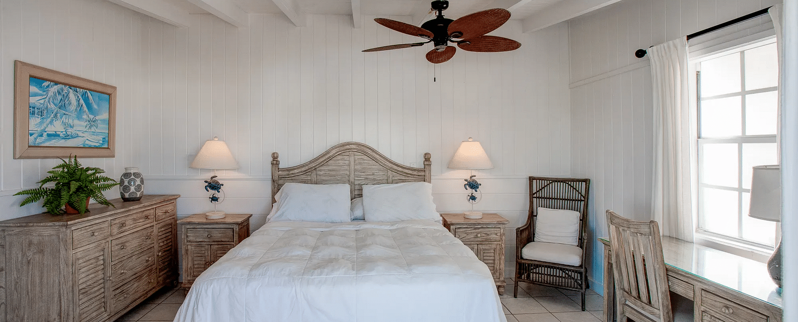 Bedroom with a double bed, ceiling fan, and natural light | Abaco Inn