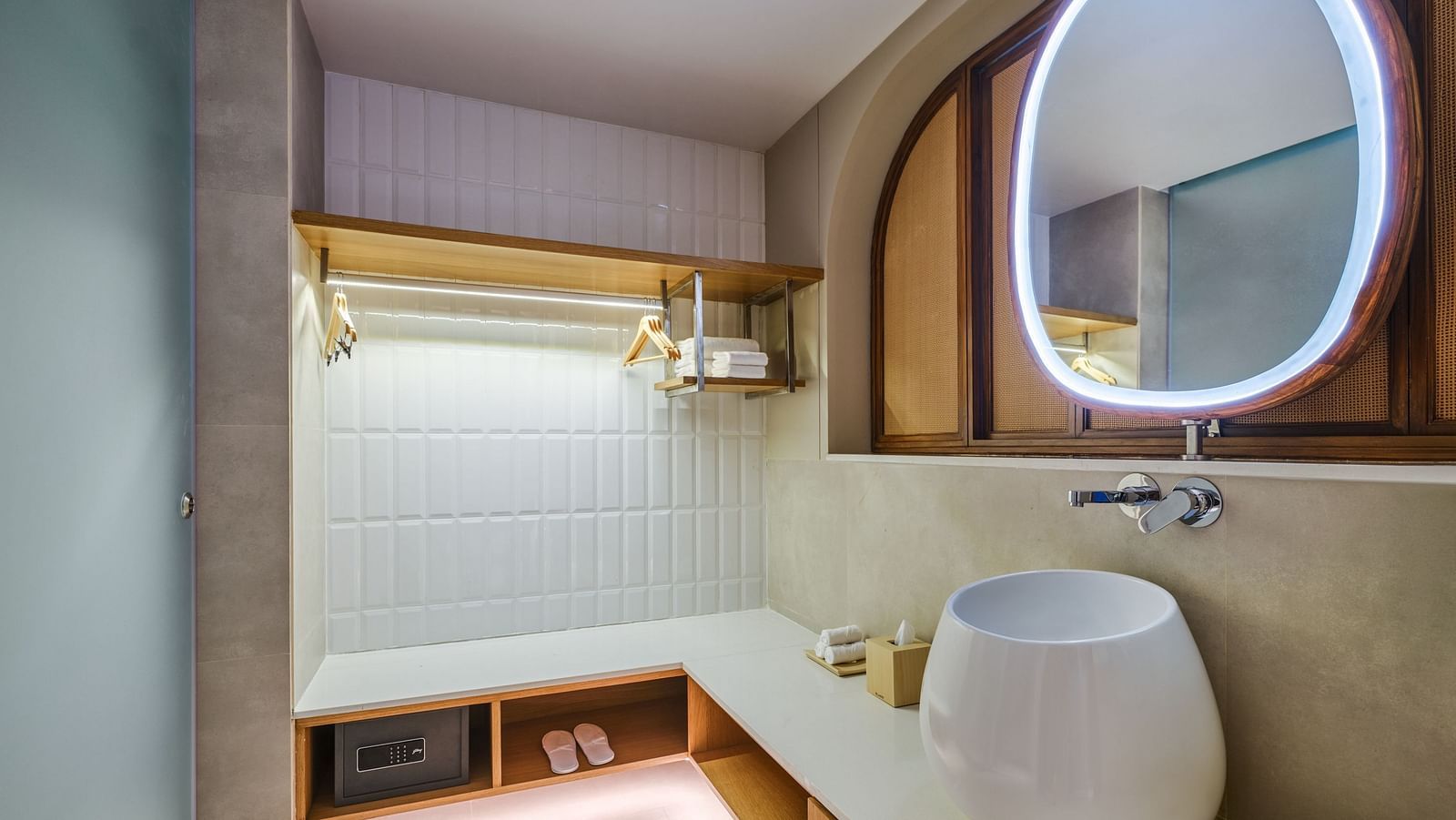 An image of the bathroom featuring ambient lighting and toiletries and a secret locker underneath the slab