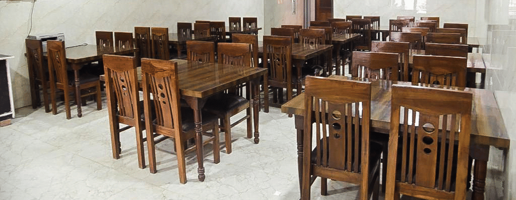Tables and chairs arranged in Agra Prasadham - Hotel Goverdhan, Agra