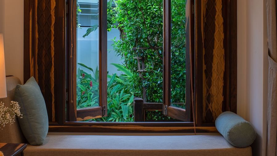 An image of a small bed and a window next to it - Alibu Resort Nha Thrang