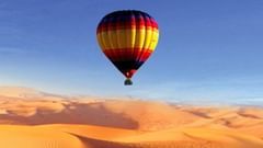 A hot air balloon gliding over the desert in Pushkar 