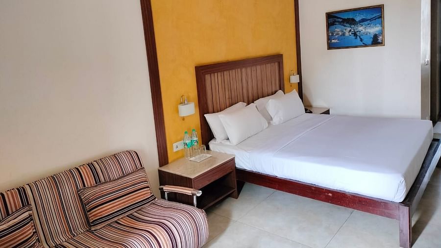 An image of bedroom with a bedside table, and a sofa next to it - VITS Lonvala