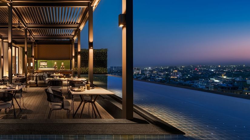 Rooftop Sky Dining at The Residency Towers Chennai, offering a stunning view after sunset, with a relaxed dining setting.