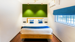 An image of a room with a bed and bed side tables - MGM Whispering Nest